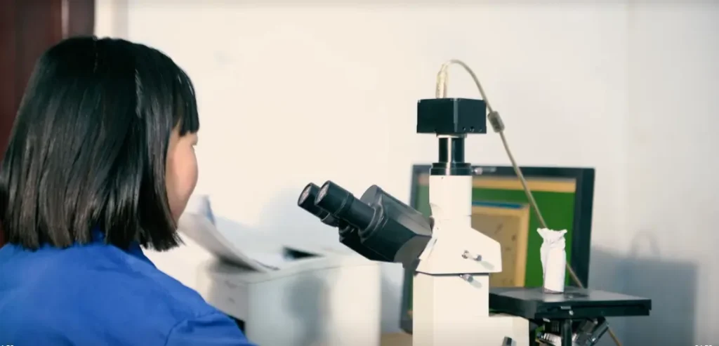 What Affects the Mechanical Properties of Metal Components? 2 Technician analyzing metal microstructure using a digital microscope system